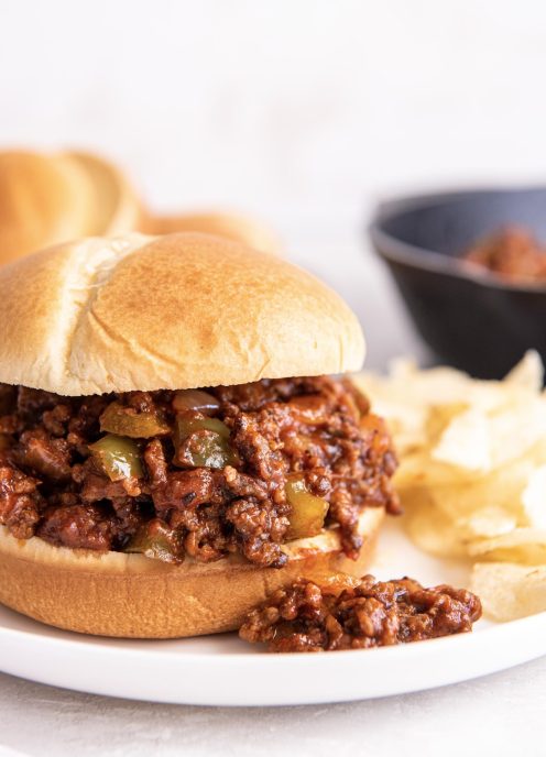 Side view of sloppy joes served on a burger bun.